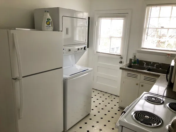 a kitchen with a refrigerator and a stove
