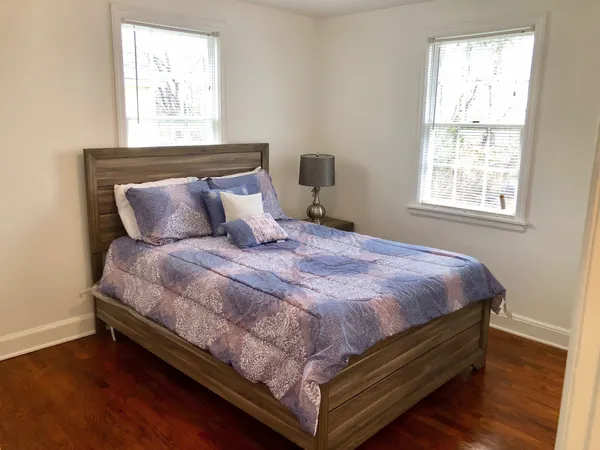 a large bed sitting in a bedroom next to a window