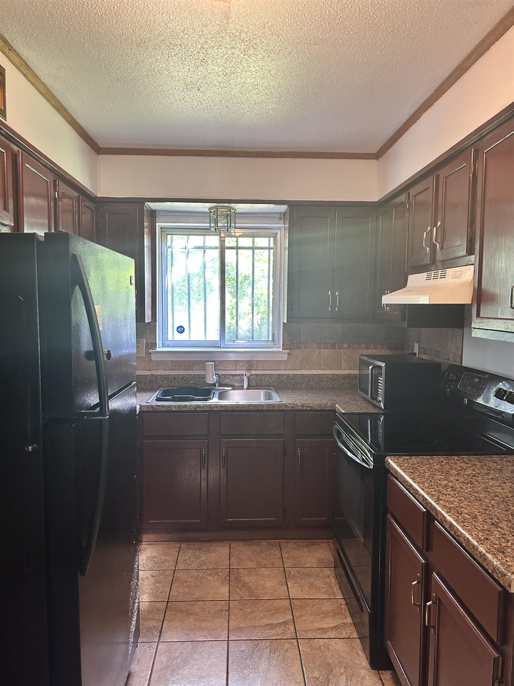 3082 Spring Hill Drive Memphis, TN 38127 - Photo 2 of 15 a kitchen with stainless steel appliances granite countertop a sink and a refrigerator