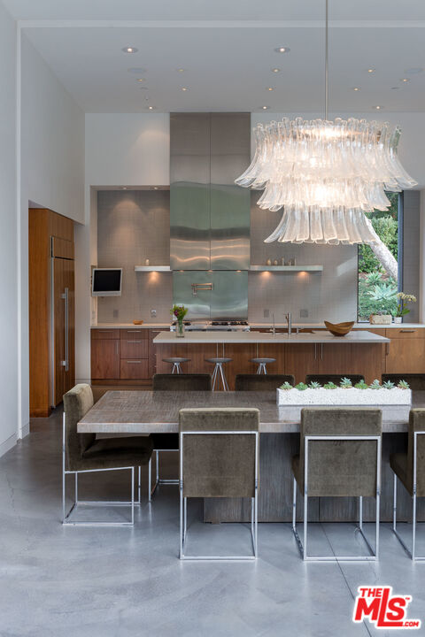 671 Latimer Road Santa Monica, CA 90402 - Photo 13 of 27 a kitchen with a stove a table and chairs in it