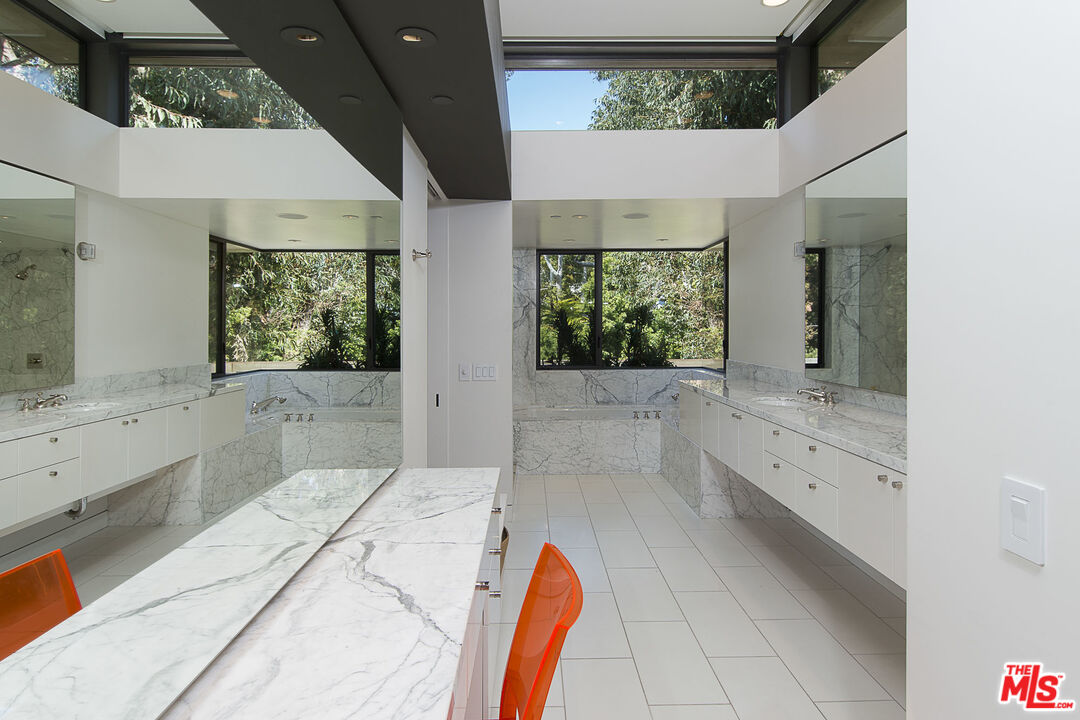671 Latimer Road Santa Monica, CA 90402 - Photo 21 of 27 a bathroom with a tub shower and sink