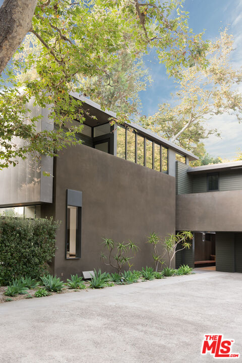 671 Latimer Road Santa Monica, CA 90402 - Photo 4 of 27 a front view of a house with a yard and garage