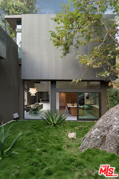 671 Latimer Road Santa Monica, CA 90402 - Photo 5 of 27 a view of a backyard with table and chairs potted plants and large tree
