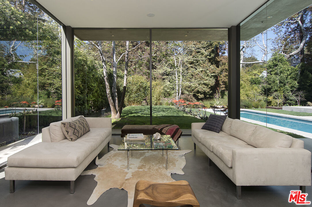 671 Latimer Road Santa Monica, CA 90402 - Photo 6 of 27 a living room with patio furniture and a floor to ceiling window