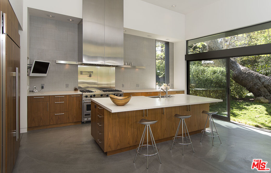 671 Latimer Road Santa Monica, CA 90402 - Photo 8 of 27 a kitchen with a sink stove and cabinets