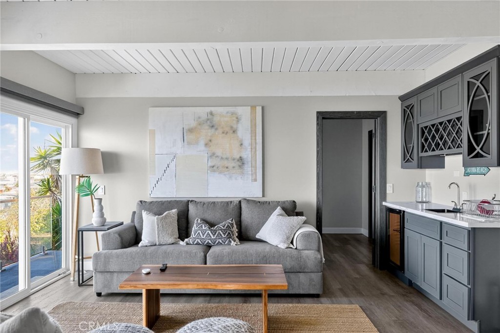 865 Quivera Street Laguna Beach, CA 92651 - Photo 15 of 23 a living room with furniture and a flat screen tv