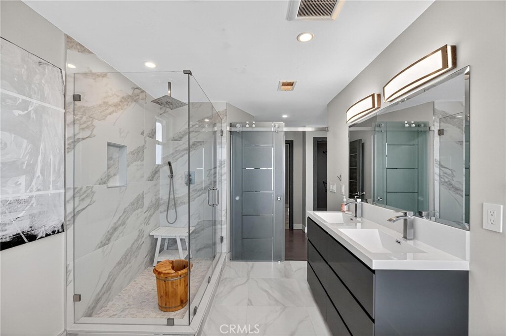 865 Quivera Street Laguna Beach, CA 92651 - Photo 18 of 23 a bathroom with a double vanity sink mirror and shower
