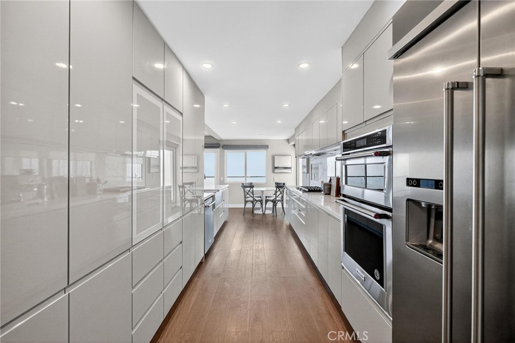 865 Quivera Street Laguna Beach, CA 92651 - Photo 7 of 23 a kitchen with stainless steel appliances a refrigerator sink and cabinets