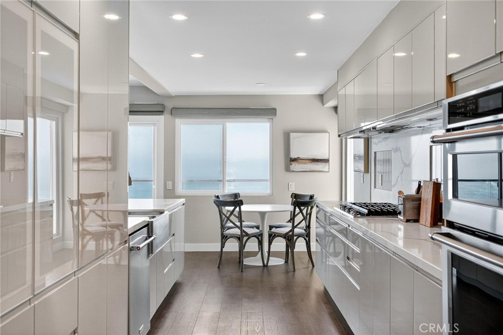 865 Quivera Street Laguna Beach, CA 92651 - Photo 8 of 23 a kitchen with stainless steel appliances a table and chairs