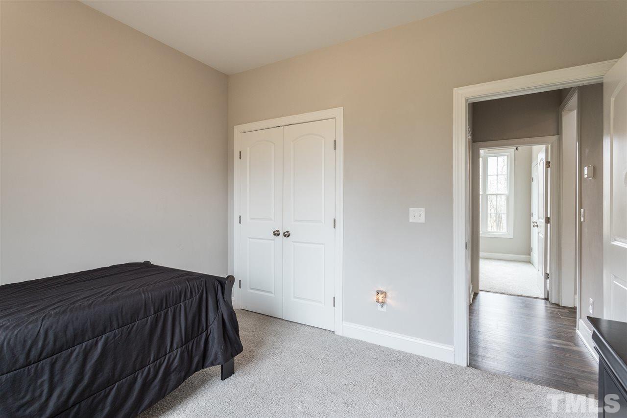3318 High Gate Road Raleigh, NC 27603 - Photo 11 of 16 a bedroom with a bed and wooden floor
