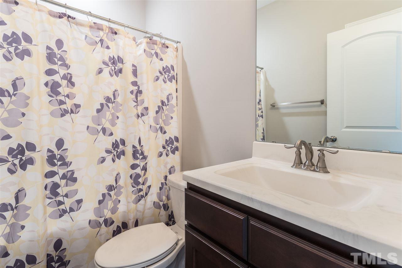 3318 High Gate Road Raleigh, NC 27603 - Photo 12 of 16 a bathroom with a sink and toilet