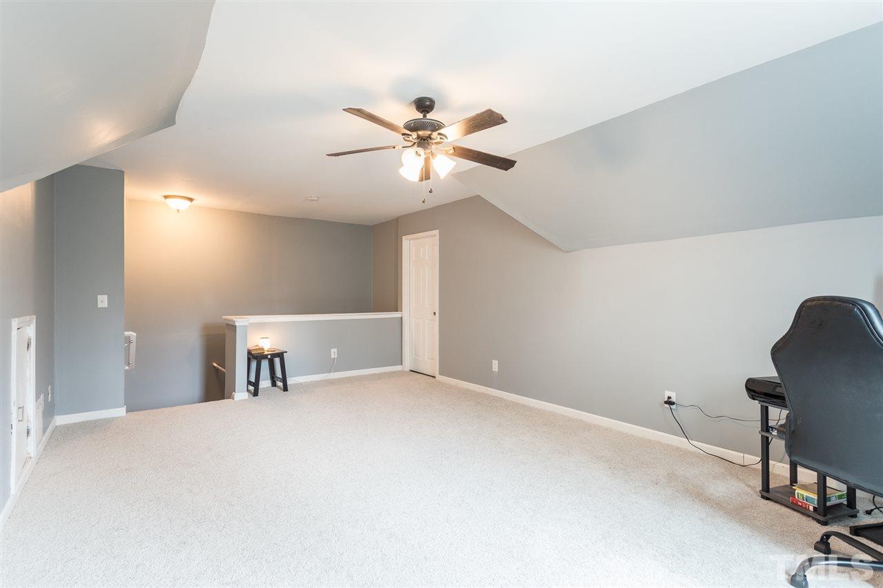 3318 High Gate Road Raleigh, NC 27603 - Photo 15 of 16 a view of a workspace with furniture and a chandelier fan
