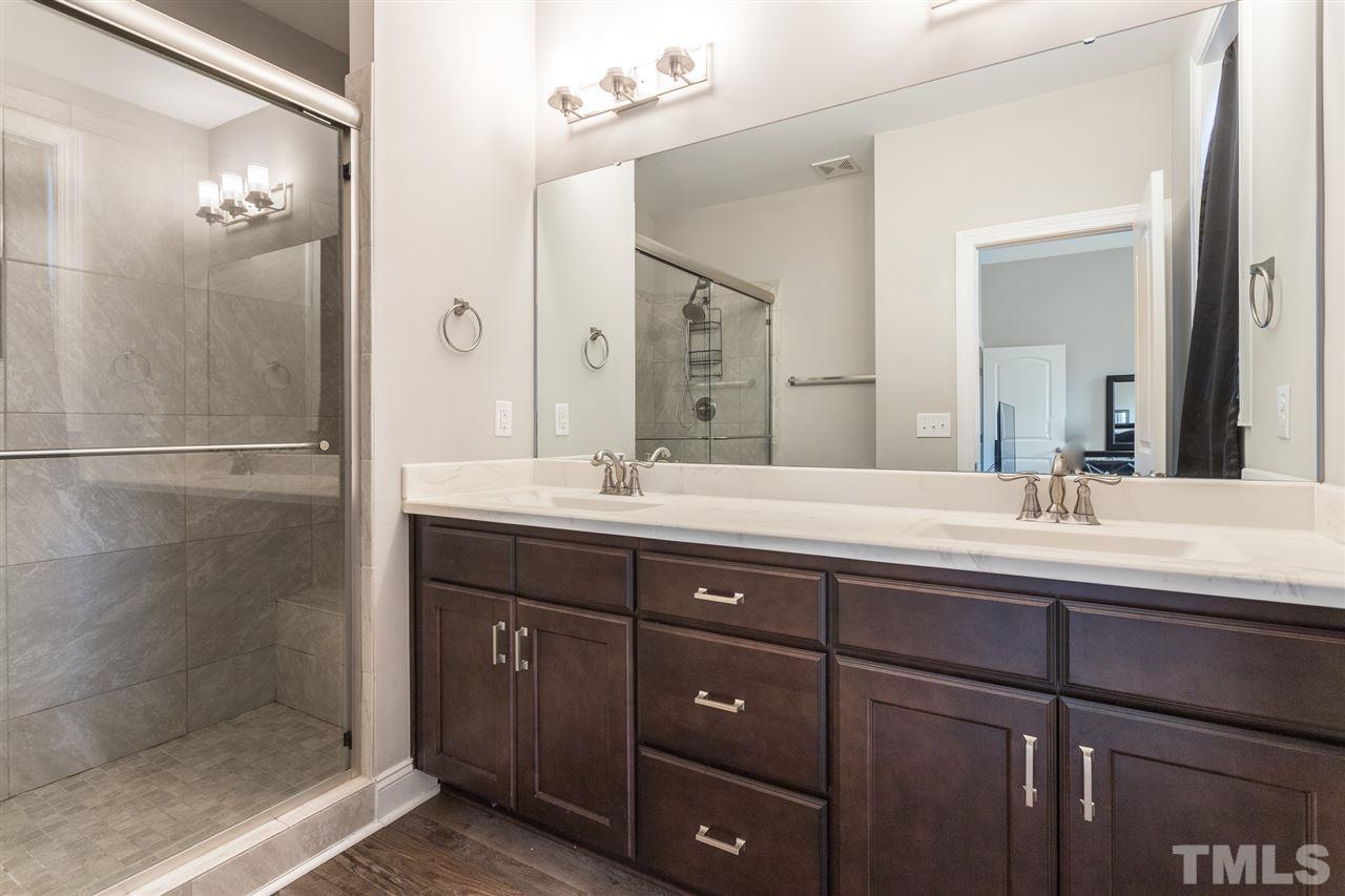 3318 High Gate Road Raleigh, NC 27603 - Photo 7 of 16 a bathroom with double vanity sinks and a shower