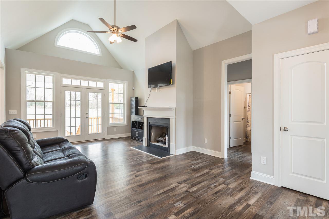 3318 High Gate Road Raleigh, NC 27603 - Photo 9 of 16 a living room with fireplace furniture and a wooden floor
