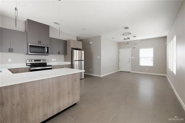 a kitchen with stainless steel appliances a refrigerator sink and stove