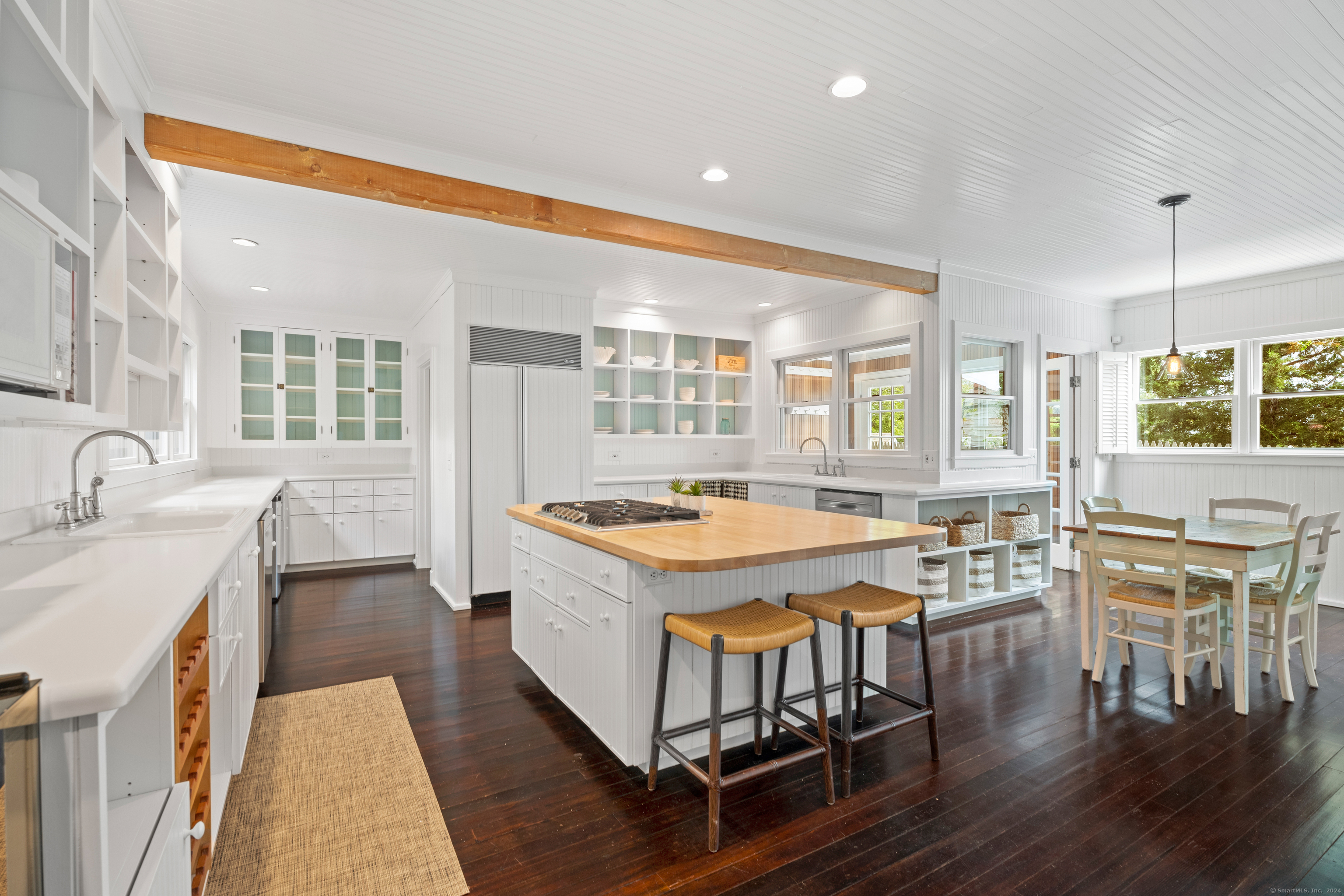 118 Middle Beach Road Madison, CT 06443 - Photo 12 of 28 a kitchen with a stove and wooden cabinets