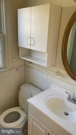 a bathroom with a sink a toilet and mirror