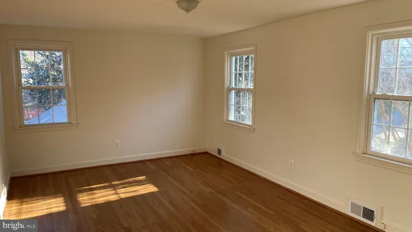 a view of room with window and wooden floor