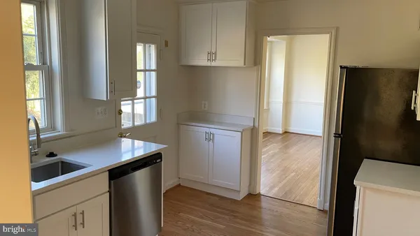 a kitchen with a refrigerator and a sink