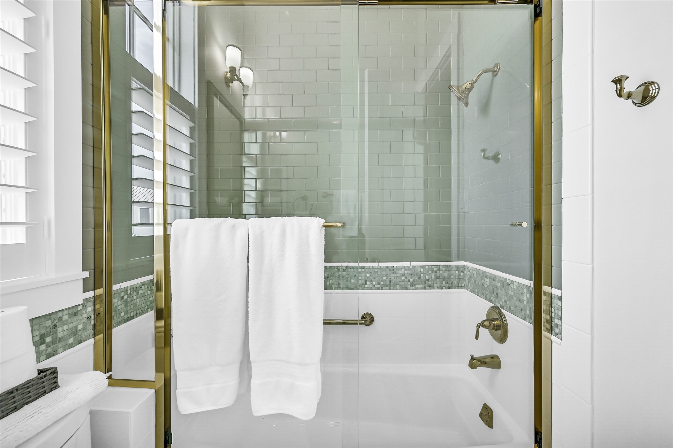 817 Positano Road Galveston, TX 77550 - Photo 39 of 50 The full bath includes a tub and shower combination surrounded by classic tilework and glass enclosure details. Designed for both convenience and comfort, this bathroom provides a private retreat for guests.