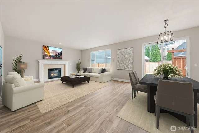 a dining room filled chandelier and kitchen view
