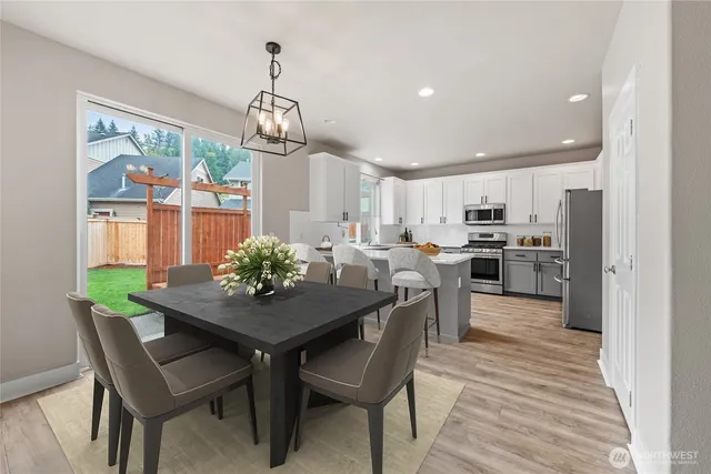 a kitchen with kitchen island a white counter top space stainless steel appliances and cabinets