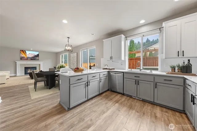 a kitchen with sink cabinets and wooden floor
