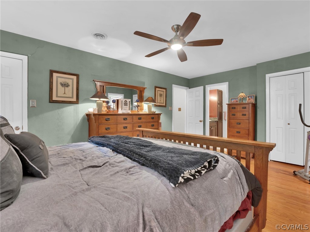 13618 Hunts Bridge Road Midlothian, VA 23112 - Photo 38 of 42 a bedroom with a large bed and a chandelier