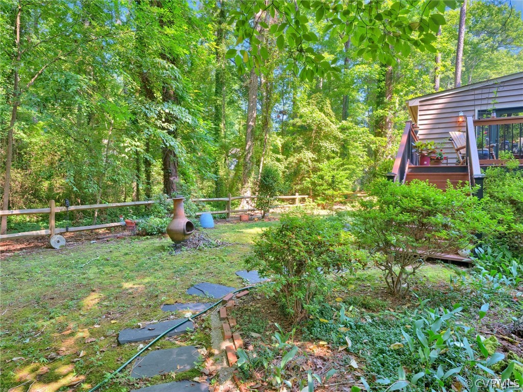 13618 Hunts Bridge Road Midlothian, VA 23112 - Photo 8 of 42 a view of a backyard with table and chairs and wooden fence