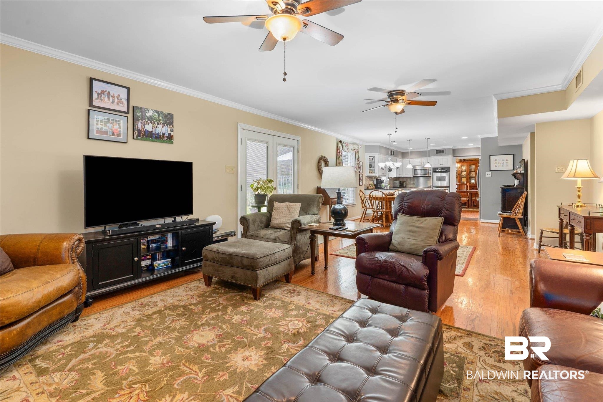559 East Cumberland Road Mobile, AL 36608 - Photo 12 of 48 Living room with ceiling fan, crown molding, and light wood-style flooring