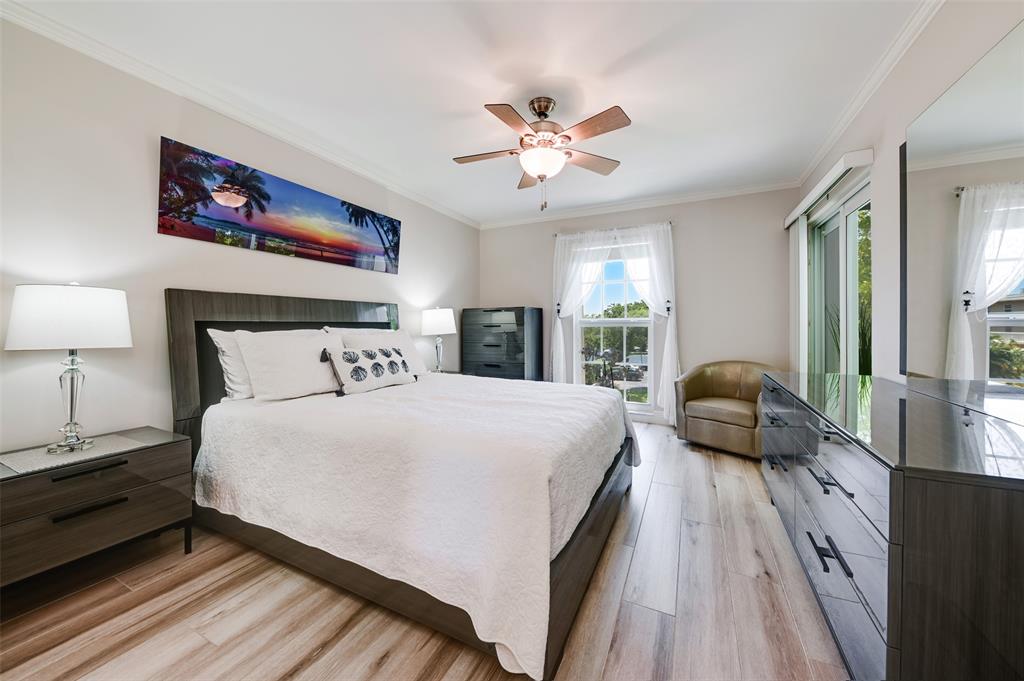 773 Jeffery Street, Unit 4305 Boca Raton, FL 33487 - Photo 11 of 22 a spacious bedroom with a bed a couch and a chandelier