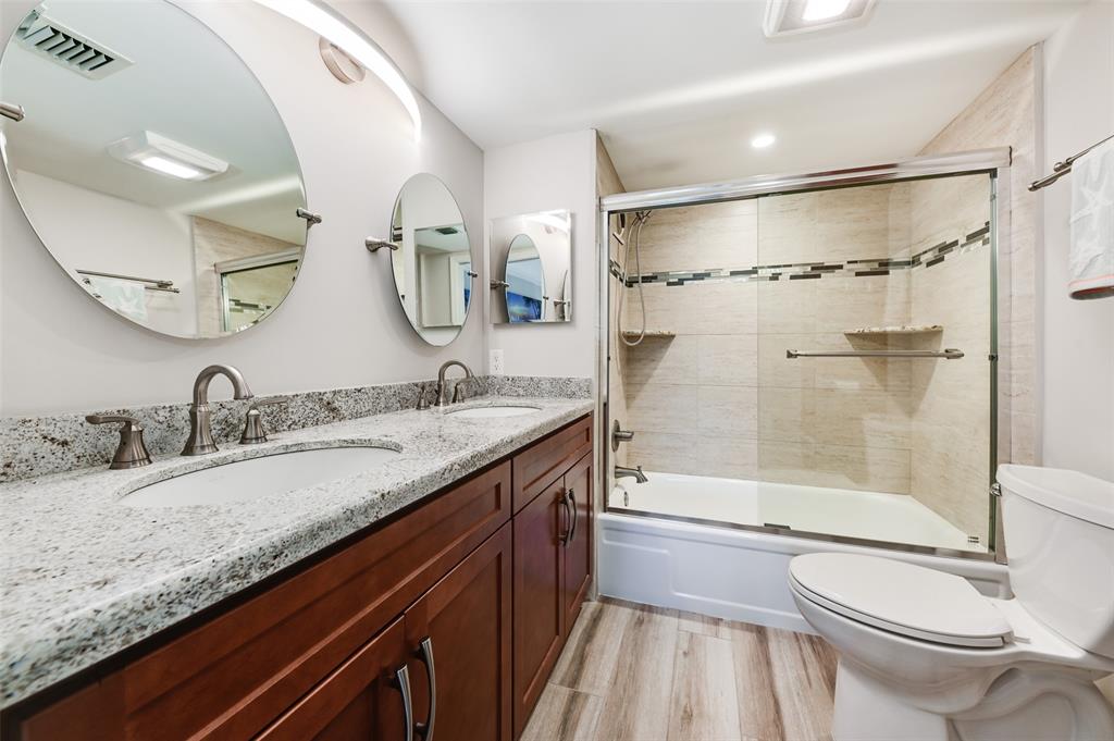 773 Jeffery Street, Unit 4305 Boca Raton, FL 33487 - Photo 12 of 22 a bathroom with a granite countertop sink toilet and shower
