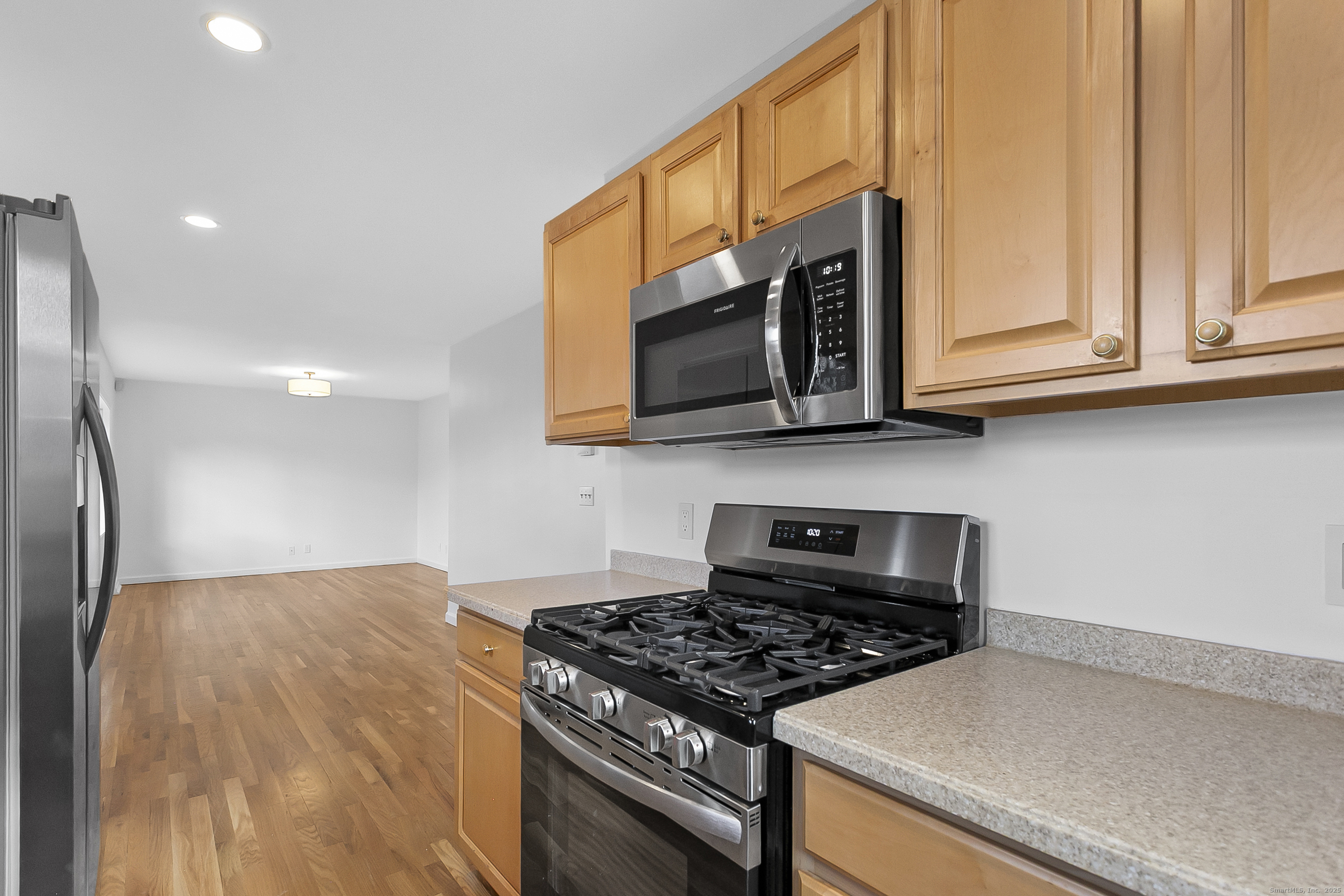 23 Berkshire Road Ansonia, CT 06401 - Photo 12 of 23 a kitchen with stainless steel appliances granite countertop a stove a microwave and a refrigerator
