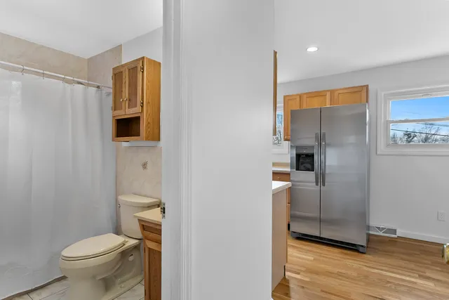 a bathroom with a toilet and a shower