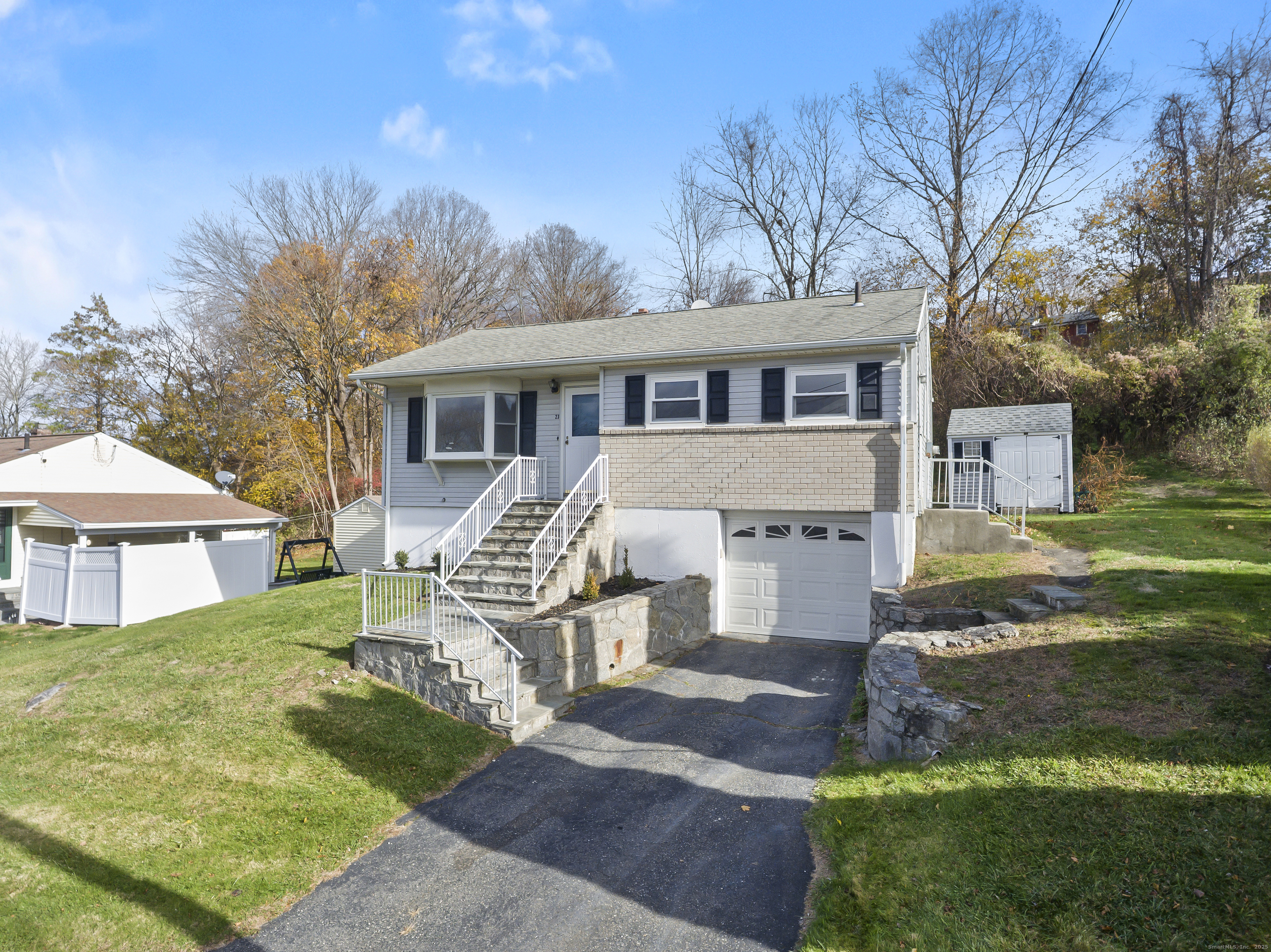 23 Berkshire Road Ansonia, CT 06401 - Photo 2 of 23 a front view of a house with yard porch and tree