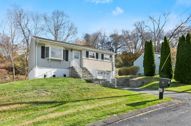 a house that has a tree in front of it