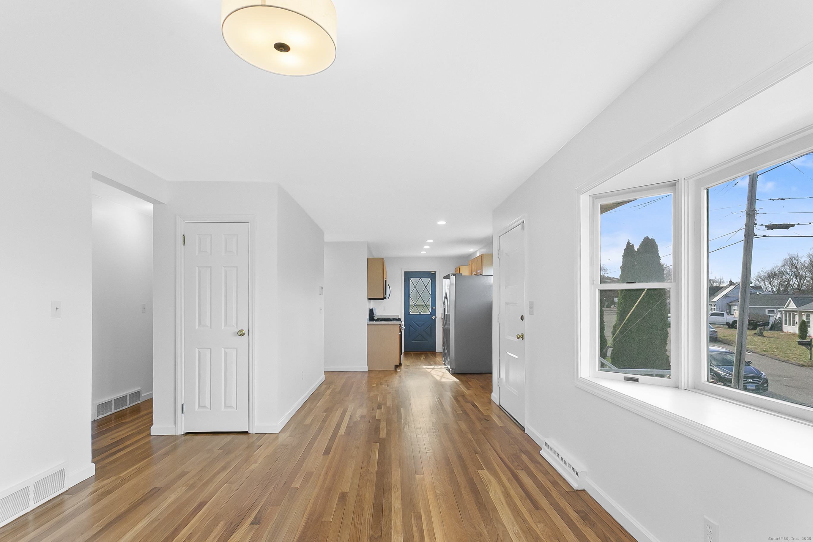 23 Berkshire Road Ansonia, CT 06401 - Photo 7 of 23 a view of a hallway with wooden floor and staircase
