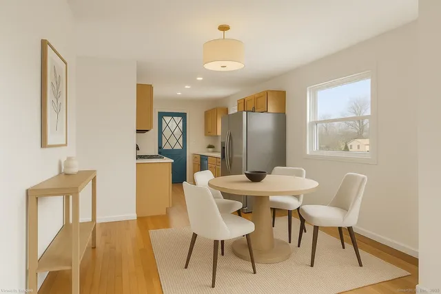 a view of a dining room with furniture window and wooden floor