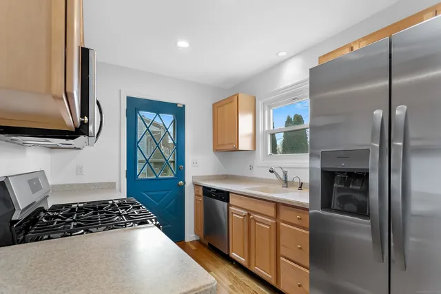 a kitchen with a sink stove and refrigerator