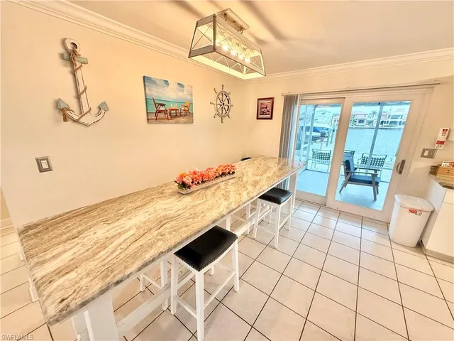 a living room with a floor to ceiling window and a rug