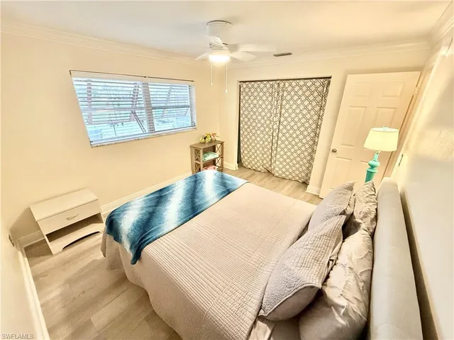 a bed sitting in a bedroom next to a window