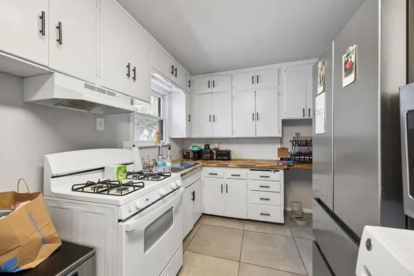 a kitchen with cabinets appliances a sink and a stove
