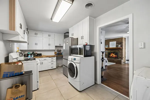 a kitchen that has a lot of cabinets in it and appliances