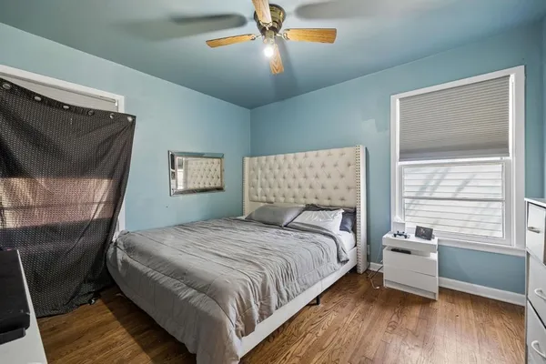 a bedroom with a bed and a chandelier