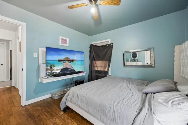 a bedroom with a bed and a painting on the wall