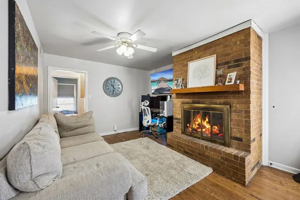a living room with furniture and a fireplace