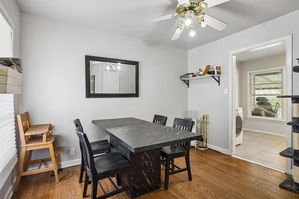 a view of a dining room with furniture and wooden floor