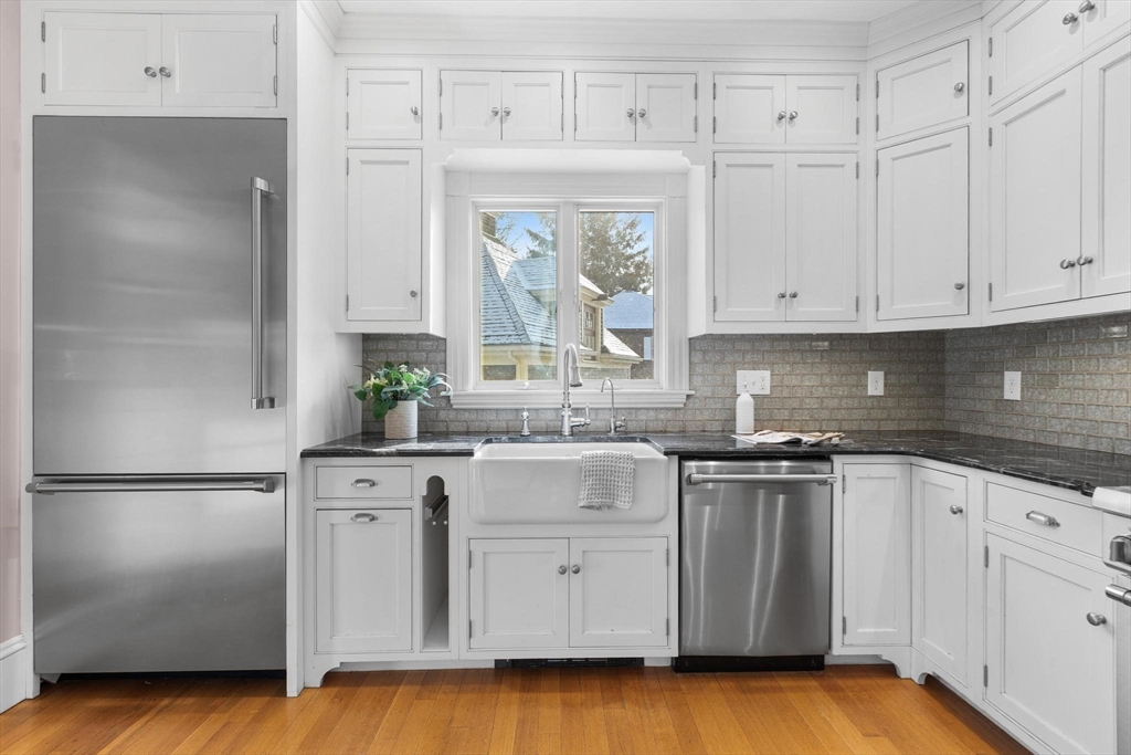 129 High Street Reading, MA 01867 - Photo 12 of 41 a kitchen with stainless steel appliances granite countertop a sink a stove and a refrigerator