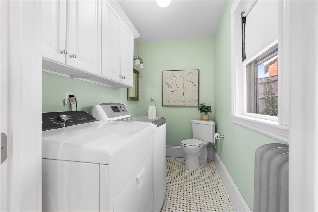 129 High Street Reading, MA 01867 - Photo 16 of 41 a bathroom with a sink a toilet and a window