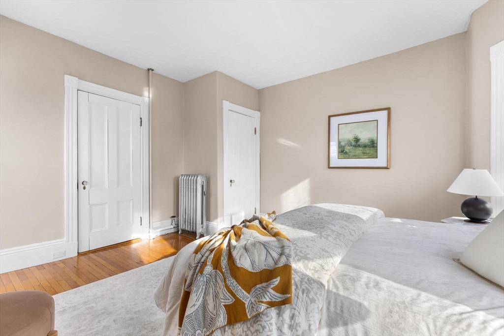 129 High Street Reading, MA 01867 - Photo 18 of 41 a bedroom with a bed and a painting on the wall